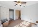 Bright bedroom featuring a ceiling fan, neutral carpet, and a closet with sliding doors at 6080 Dexter Ln, Brooksville, FL 34602