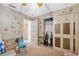 Bedroom with hand-print wallpaper and closet with sliding doors and assorted boxes at 6080 Dexter Ln, Brooksville, FL 34602