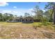 Lovely exterior of a single Gathering home with a porch and spacious front yard surrounded by trees at 6080 Dexter Ln, Brooksville, FL 34602