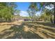 Lush backyard featuring a screened-in pool, perfect for outdoor living at 6080 Dexter Ln, Brooksville, FL 34602