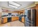 Bright kitchen featuring stainless steel appliances, wood cabinets, and a skylight at 6080 Dexter Ln, Brooksville, FL 34602