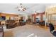 Open-concept living room with multiple seating areas and seamless flooring transition at 6080 Dexter Ln, Brooksville, FL 34602