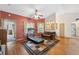 Cozy living room featuring hardwood floors, a ceiling fan, and comfortable seating at 6080 Dexter Ln, Brooksville, FL 34602