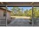 Inviting outdoor patio with a view of lush trees, offering a serene and private relaxation space at 6080 Dexter Ln, Brooksville, FL 34602