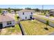 Aerial shot features a backyard with privacy fence, a small patio area, and sparse landscaping at 6561 Seaway Dr, Brooksville, FL 34604