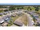 Aerial view of modern homes, manicured lawns, and surrounding green space in a quiet neighborhood at 6561 Seaway Dr, Brooksville, FL 34604
