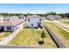 Backyard aerial view shows a privacy fence, patio, and modest landscaping at 6561 Seaway Dr, Brooksville, FL 34604