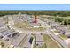 Aerial view of a neighborhood with sidewalks and street lights surrounded by trees and vegetation at 6561 Seaway Dr, Brooksville, FL 34604