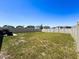Large fenced backyard with a patio and sparse landscaping at 6561 Seaway Dr, Brooksville, FL 34604
