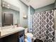 Bathroom with granite counter, and shower with patterned curtain at 6561 Seaway Dr, Brooksville, FL 34604