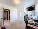 Bedroom with neutral colors leads to the bathroom and features a wall-mounted television at 6561 Seaway Dr, Brooksville, FL 34604