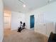 Bright bonus room features plush carpet, ample natural light, and access to laundry room at 6561 Seaway Dr, Brooksville, FL 34604