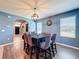A dining room featuring a modern chandelier, with seating for eight at 6561 Seaway Dr, Brooksville, FL 34604