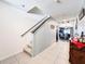 Hallway with tile floor leading to a staircase and dining area at 6561 Seaway Dr, Brooksville, FL 34604