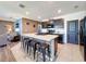 Kitchen island with bar stool seating and granite countertops at 6561 Seaway Dr, Brooksville, FL 34604