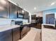 Kitchen with black appliances, tile floors and dark cabinets at 6561 Seaway Dr, Brooksville, FL 34604
