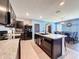 Bright kitchen with island, stainless appliances, tile floors and gray countertops at 6561 Seaway Dr, Brooksville, FL 34604
