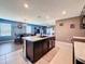 Bright kitchen with an island sink and a breakfast bar is open to the dining and living rooms at 6561 Seaway Dr, Brooksville, FL 34604