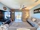 Living room with ceiling fan and sliding glass door to backyard at 6561 Seaway Dr, Brooksville, FL 34604
