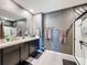 Elegant main bathroom with dual sinks, sleek fixtures, and glass enclosed shower at 6561 Seaway Dr, Brooksville, FL 34604