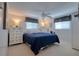 Comfortable bedroom with neutral walls, ceiling fan, and white furniture for a serene retreat at 6622 Seaview Blvd, Hudson, FL 34667