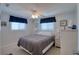 A comfy bedroom featuring a bed, white furnishings, a ceiling fan, and serene decor at 6622 Seaview Blvd, Hudson, FL 34667