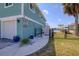 Charming turquoise two-story house with white trim, a garage, and a waterfront view at 6622 Seaview Blvd, Hudson, FL 34667