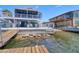 Beautiful waterfront home with a large screened porch, dock, and outdoor seating, perfect for enjoying the waterfront lifestyle at 6622 Seaview Blvd, Hudson, FL 34667