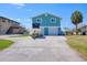 Turquoise home with a boat on the driveway and a waterfront view at 6622 Seaview Blvd, Hudson, FL 34667