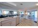 Open living space showcasing a modern kitchen, comfortable seating area, and a dining area with waterfront views at 6622 Seaview Blvd, Hudson, FL 34667