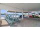 Inviting outdoor patio area featuring a table, seating, and picturesque waterfront views at 6622 Seaview Blvd, Hudson, FL 34667