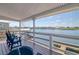 Waterfront patio with comfortable Adirondack chairs overlooking serene water view and boat dock at 6622 Seaview Blvd, Hudson, FL 34667