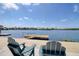 Inviting waterfront view with Adirondack chairs and private dock, perfect for relaxing and enjoying the serene surroundings at 6622 Seaview Blvd, Hudson, FL 34667