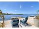 Scenic waterfront view with Adirondack chairs and a private dock at 6622 Seaview Blvd, Hudson, FL 34667