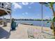 Waterfront view from the patio with seating and tropical landscaping at 6622 Seaview Blvd, Hudson, FL 34667