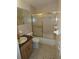 Bathroom with tile flooring, a mirror, and a bathtub with a glass sliding door at 6636 Timbercove Ln # 6636, New Port Richey, FL 34653