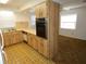 The open kitchen with breakfast bar and a view into the carpeted living area at 6636 Timbercove Ln # 6636, New Port Richey, FL 34653