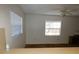 Bright living room featuring a ceiling fan and two windows at 6636 Timbercove Ln # 6636, New Port Richey, FL 34653