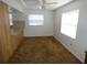 A small living room featuring carpet, white walls, and a glimpse into the kitchen at 6636 Timbercove Ln # 6636, New Port Richey, FL 34653
