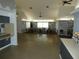 Spacious meeting room with a vaulted ceiling, modern lighting, and many tables and chairs for group gatherings at 6636 Timbercove Ln # 6636, New Port Richey, FL 34653