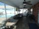 Enclosed patio space featuring a brick wall, multiple ceiling fans, and a clear view of the outdoor pool at 6636 Timbercove Ln # 6636, New Port Richey, FL 34653