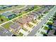 Aerial view of the neighborhood with well maintained streets, lush backyard spaces, and sparkling, screened-in pools at 680 Argyll Dr, Spring Hill, FL 34609
