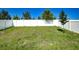 Wide open backyard enclosed by a white vinyl fence offering a private outdoor space at 680 Argyll Dr, Spring Hill, FL 34609