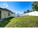 Backyard featuring a fenced-in yard, well-maintained lawn, and landscaping at 680 Argyll Dr, Spring Hill, FL 34609