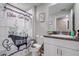 Well-lit bathroom with a decorative shower curtain, toilet and single sink at 680 Argyll Dr, Spring Hill, FL 34609