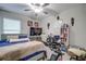 Spacious bedroom featuring a ceiling fan, workspace, and cozy decor at 680 Argyll Dr, Spring Hill, FL 34609
