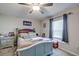 Comfortable bedroom with natural light, ceiling fan, and neutral decor at 680 Argyll Dr, Spring Hill, FL 34609