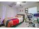 Bedroom featuring a ceiling fan, workspace with a computer, and cozy decor at 680 Argyll Dr, Spring Hill, FL 34609