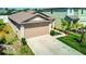 Exterior view of home with two-car garage, lush front lawn, and ample driveway space at 680 Argyll Dr, Spring Hill, FL 34609