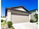 Two-car garage with beige door and concrete driveway at 680 Argyll Dr, Spring Hill, FL 34609